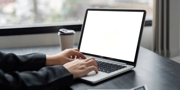istock Business Professional Working on Laptop with Blank Screen Mockup in Modern Office Setting 2160694937
