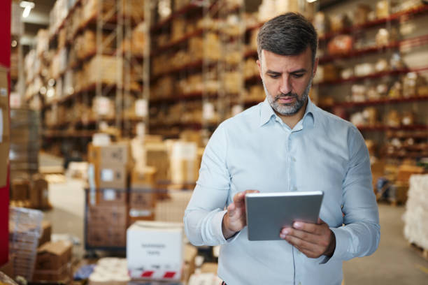 istock Male manager working on touchpad in distribution warehouse. 2160695092