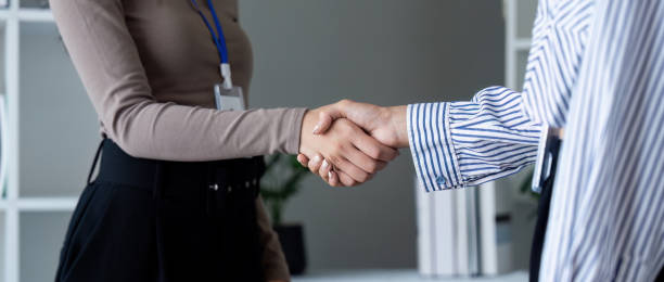 istock Business Professionals Shaking Hands in Modern Office. symbolizing agreement and partnership 2160695683