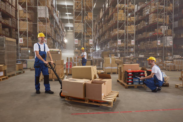 istock Team of happy workers working with packages in storage room. 2160695863