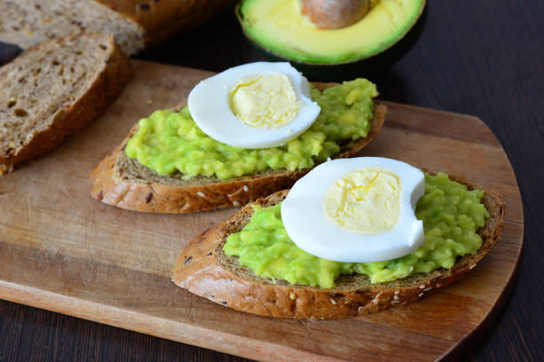 istock an avocado toast with egg on the wooden cutting board 2160696332