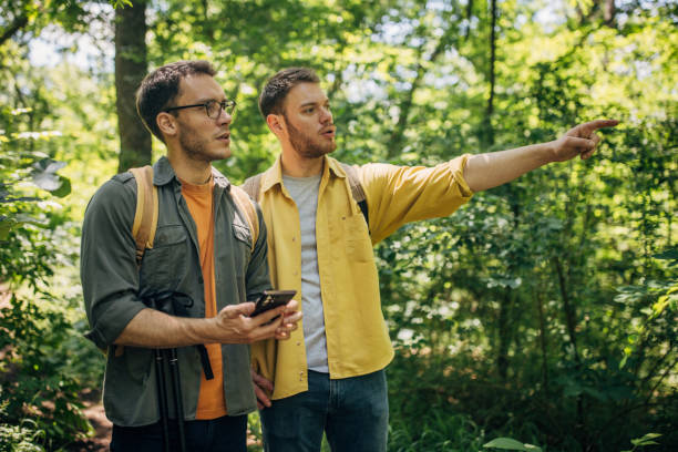 istock Friends deciding on a path in the green forest 2160696635