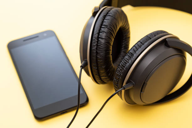 istock Headphones and smartphone on a yellow background 2160697518