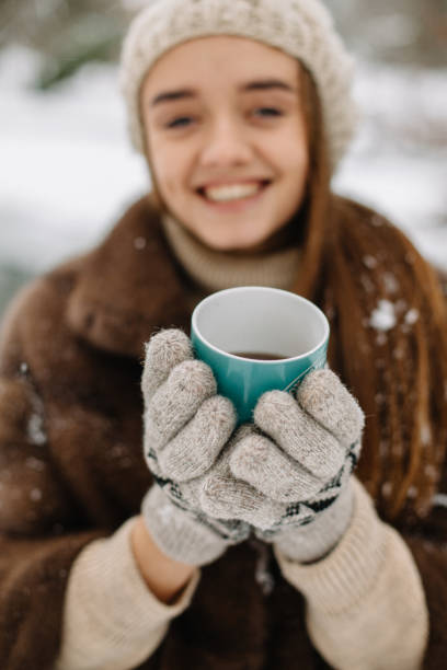 istock girl drinking hot coffee in winter 2160698265