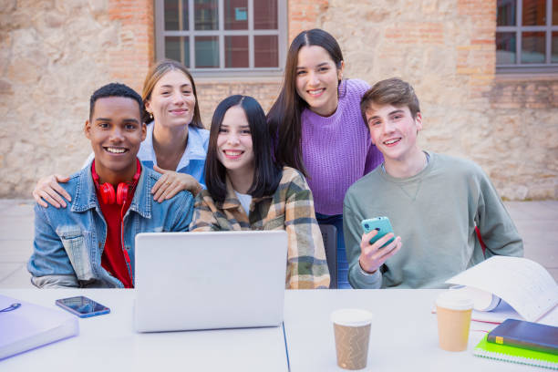 istock Group of students, prepare for university exams, use a laptop looking at camera 2160698399