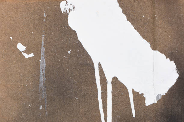 Background with random white paint strokes on brown cardboard