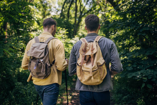 istock Rear view of two hikers walking on a forest trail 2160702045