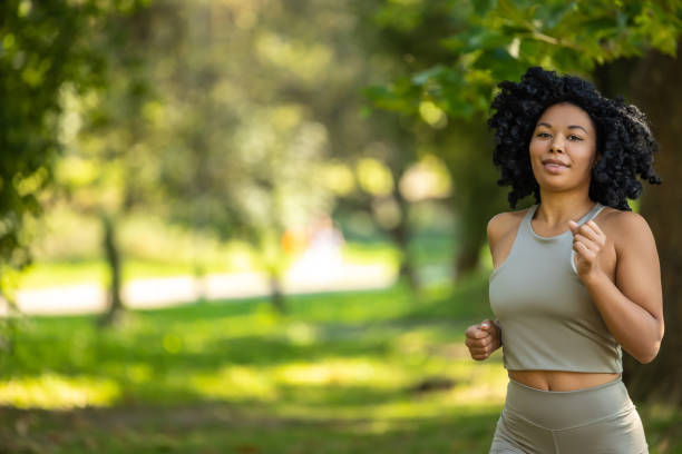 istock Brunette woman running in a park and looking focused 2160702429