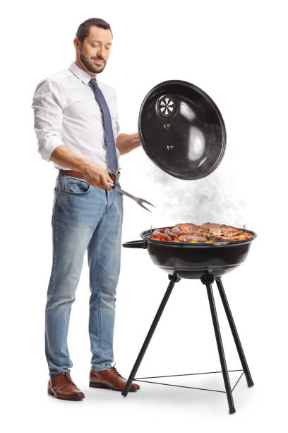 istock Businessman making a barbecue and holding a turner 2160703259