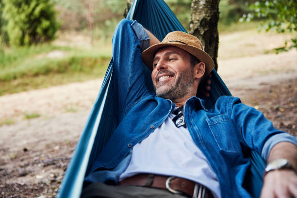 istock Happy adult man relaxing in hammock 2160707294