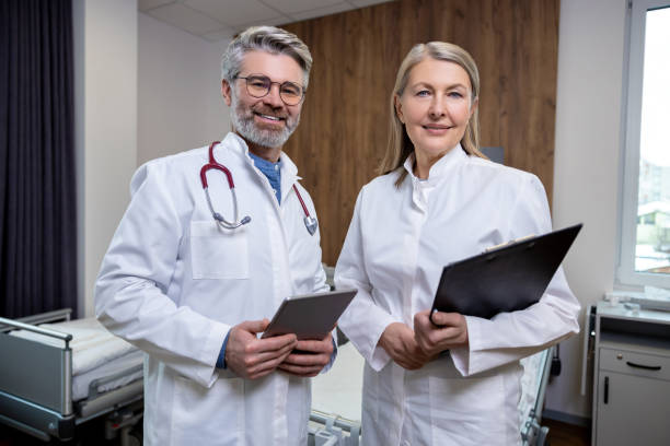 istock Doctors in lab coats standing close and looking confident 2160707526