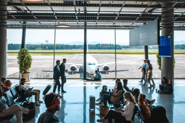 istock Diverse People Casually Waiting At Departures Terminal 2160708250