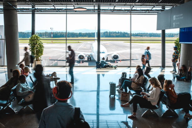 istock Diverse People Casually Waiting At Departures Terminal 2160708252