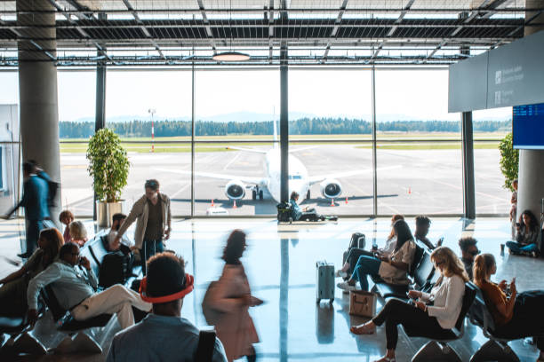 istock Diverse People Casually Waiting At Departures Terminal 2160708254