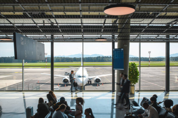 istock Diverse People Casually Waiting At Departures Terminal 2160708271