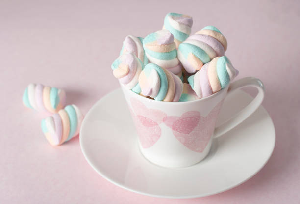 light pink and white marshmallows in a beautiful ceramic cups with pink hearts, Concept Mother's Day gift, Valentine's Day. High quality photo