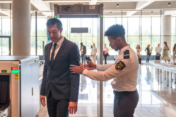 istock Afro-American Male Security Employee Checking a Male Passenger 2160709518