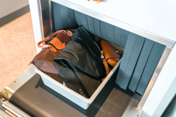 istock Plastic Tray With Hand Luggage Going Into X-Ray Machine at Baggage Screening 2160709585
