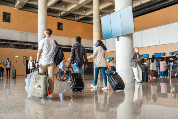 istock Diverse Group Of People Dragging Suitcases Around The Airport 2160709708