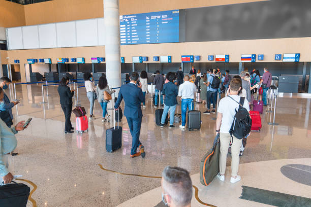 istock People Lining Up At A Check In Area At The Airport 2160709925
