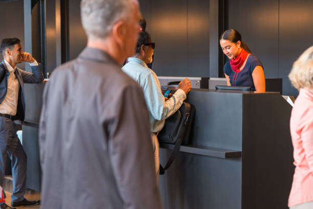 istock Young Adult Asian Airline Stewardess Checking A Boarding Pass 2160709936