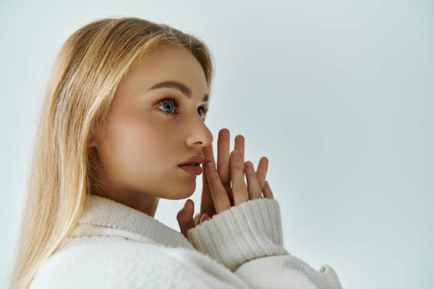 istock A young woman in a white sweater, lost in thought. 2160710080