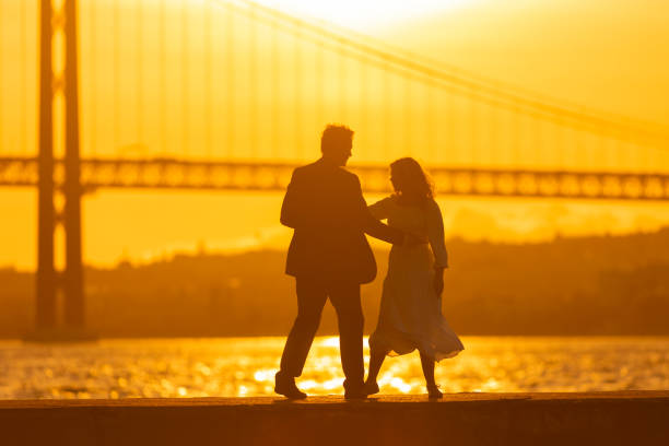 istock Couple Dancing at Sunset by a Bridge 2160710323