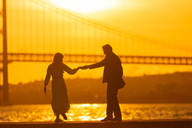 istock Couple Dancing at Sunset near water 2160710628
