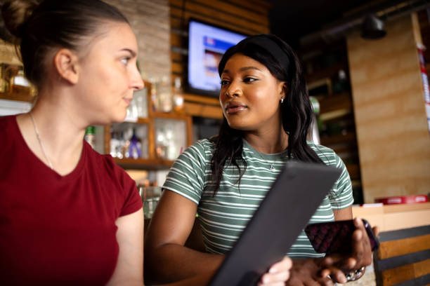 istock Young women working as waitresses at cafe and purchasing goods using digital tablet 2160713996