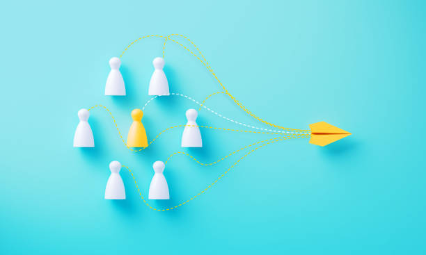 istock Paper Plane Flying Away From Human Shaped Pawns On Blue Background 2160715139