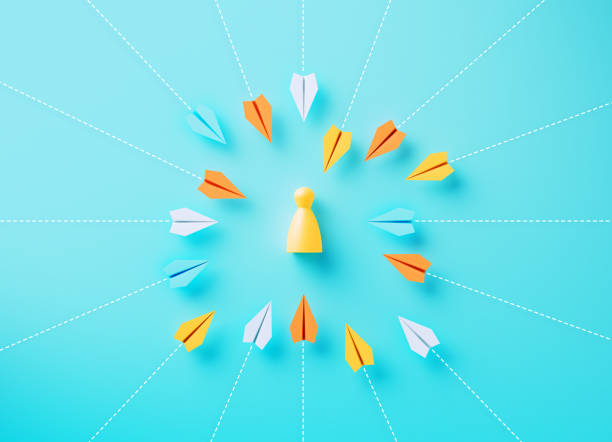 istock Paper Planes Flying Towards A Human Shaped Pawn On Blue Background 2160715453