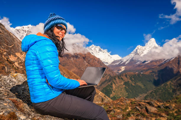 istock Young woman using laptop in Himalayas, Nepal 2160716266