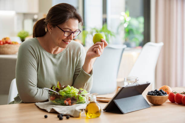 istock Woman is searching healthy recipes using digital tablet at home 2160717048
