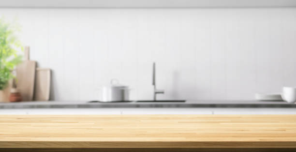 istock Wood table top counter  island  on blur minimal contemporary kitchen wall 2160720567