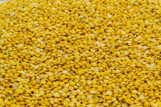 Close-up view of stacked yellow lentils