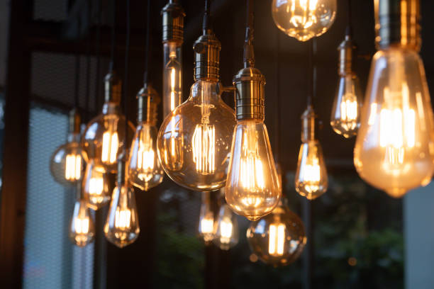 istock A bunch of light bulbs hanging from the ceiling 2160722351