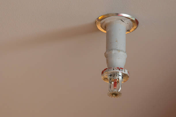 istock A white fire sprinkler is hanging from the ceiling 2160722531
