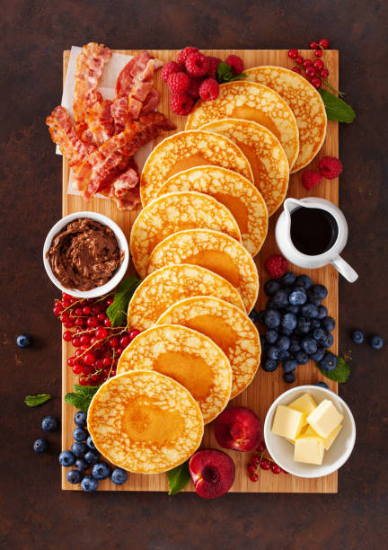 istock american pancake board with bacon berries maple syrup butter 2160723726