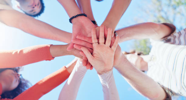 istock Friends, people and hands together with low angle outdoor for teamwork, unity and support in nature. Group, team building and solidarity for collaboration, partnership and motivation with diversity 2160723977