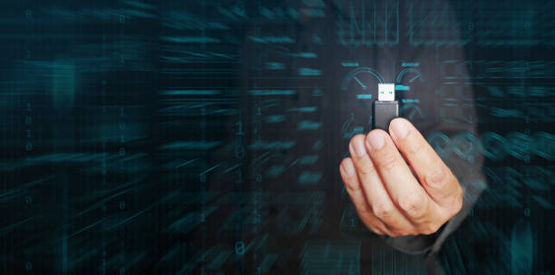 Digital data storage and sharing technology concept. Hand holds a flash drive storing much datum and information for further use, transfer, share, and analysis.