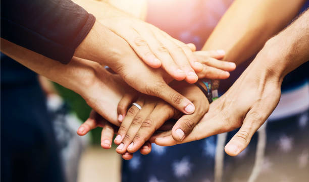 istock Team building, stack hands and people outdoor for celebration, success or motivation. Group, friends and huddle together closeup for solidarity of community with trust, connection or support for goal 2160725591