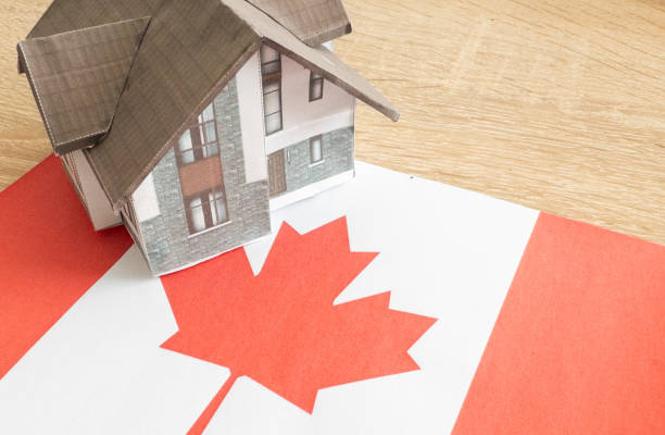 istock Small house on a flag - Living or migrating to Canada 2160726232