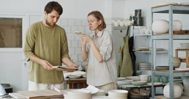 istock Husband and Wife Working in Ceramic Workshop Creating and Packing Orders 2160727002