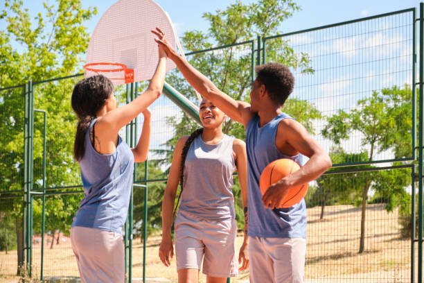 istock Young basketball players giving high five after scoring a point 2160728477