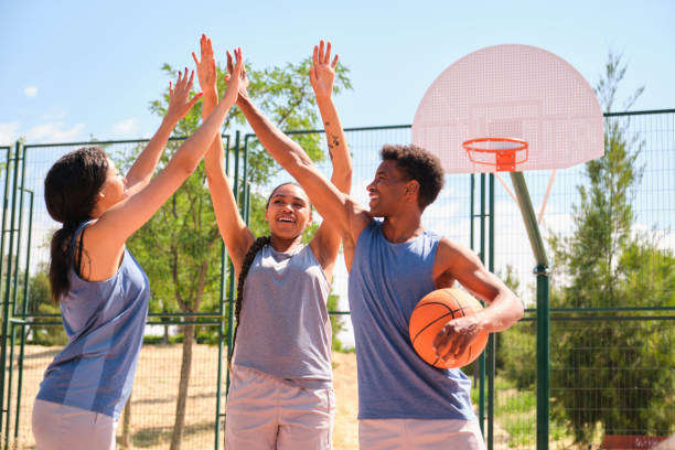 istock Basketball players giving high five after winning match 2160728617