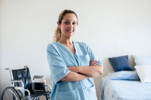 portrait of smiling young nurse holding arms crossed