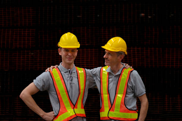 Blue collar workers are working at steel warehouse. Blue collar worker and industry concept.