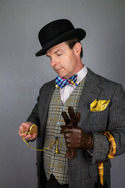 istock Gentleman in Tweed Suit Looking at Pocket Watch 2160732199