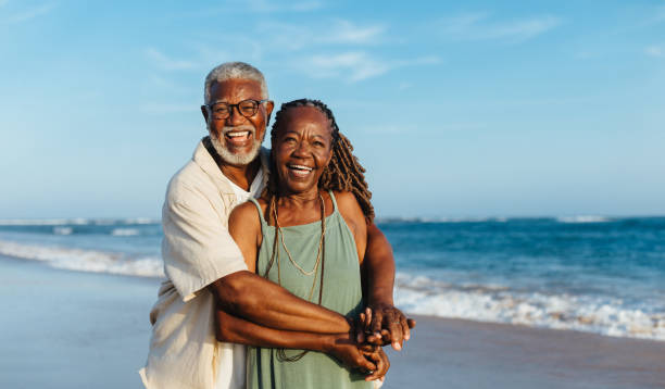 istock Happy mature couple embracing on a sunny beach 2160732968