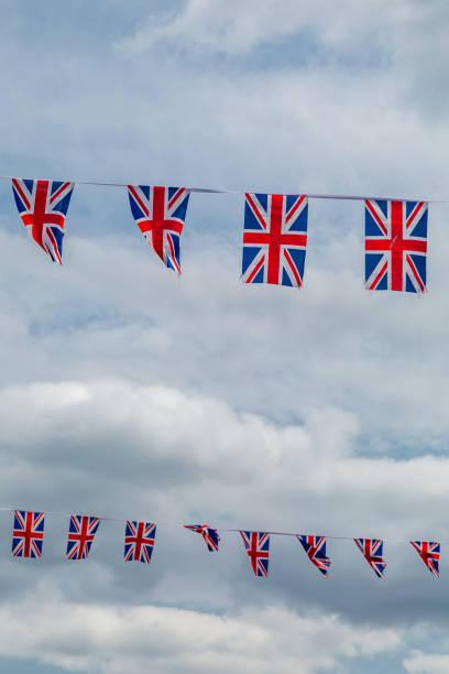 istock Looking up at union jack bunting blowing in the wind 2160736905